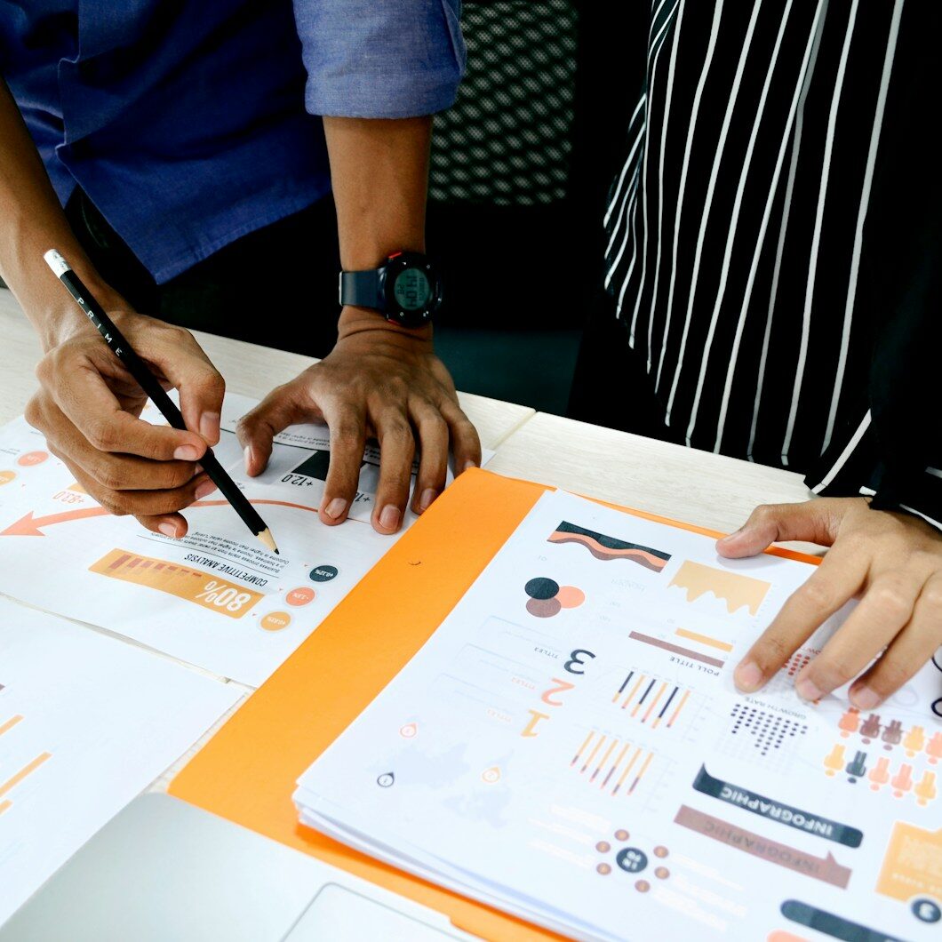 person in blue shirt writing on white paper