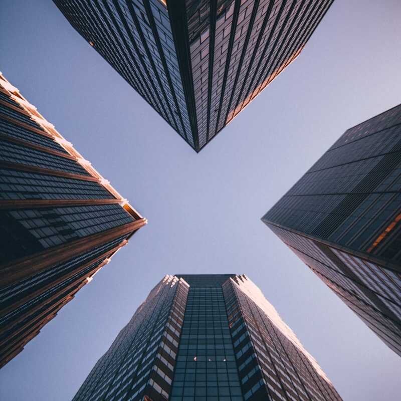 low-angle photography of four high-rise buildings